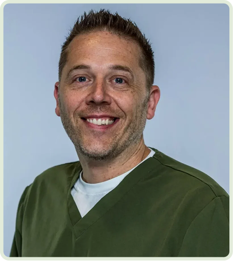 Smiling man in medical scrubs