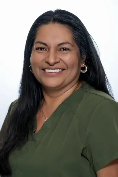 Smiling woman in medical scrubs