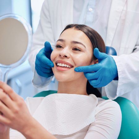 Dentist, mirror and woman check smile after teeth cleaning, braces and dental consultation. Healthcare, dentistry and happy female patient with orthodontist for oral hygiene, wellness and cleaning.